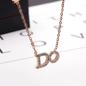 Macro shot of rose gold DO pendant with sparkling rhinestones on a cylinder necklace chain