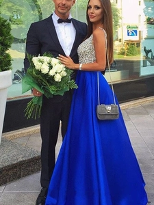 Detail view of a royal blue satin evening gown with sparkling silver sequin bodice