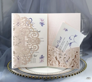 Detailed laser-cut lace wedding invitation set with floral inner card and RSVP card