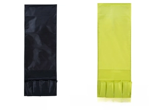 Detail view of black and green bedside storage hanging bags with four organized pockets
