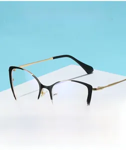 Detail of cat-eye anti-blue light glasses with black and gold metallic frame on stand