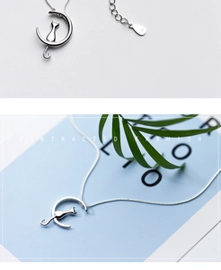 Macro view of S925 hallmark on silver crescent moon and cat silhouette pendant necklace