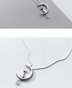 Macro detail of S925 sterling silver moon and cat pendant necklace in minimalist style