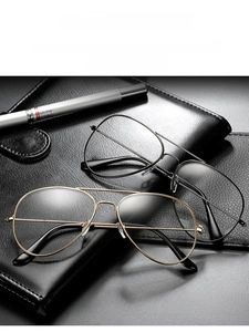 Classic aviation metal frame glasses in black and gold on a professional notebook