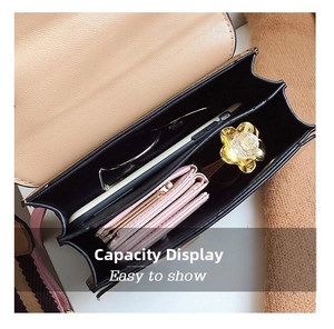 Crossbody bag interior showing large capacity for phone, wallet, and sunglasses