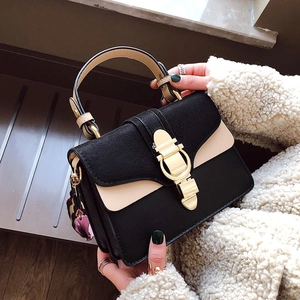 Minimalist black and white contrast leather handbag with gold round clasp lock