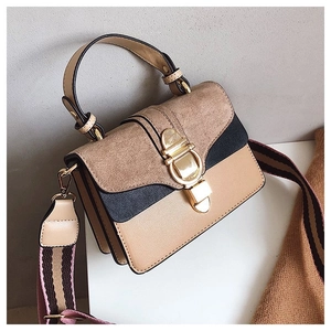 Detail of color-block crossbody bag featuring suede texture and gold metal lock