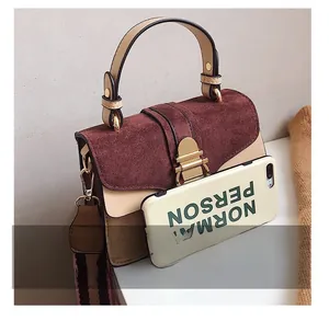 Detailed comparison of mini crossbody bag size next to a smartphone for scale