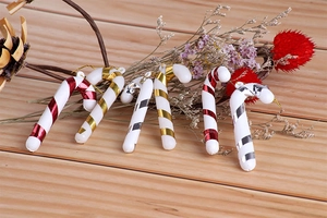 Close-up of colorful red, gold, and silver spiral striped Christmas cane ornaments