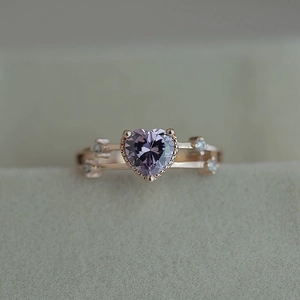 Elegant 14k rose gold ring featuring a heart-shaped purple zircon and clear side stones
