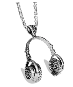 Detailed close-up of a silver music headphone pendant with vintage metal textures