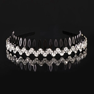 Detail of wavy rhinestone headband with non-slip teeth on a reflective black base