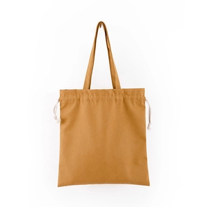 Detail of tan canvas drawstring tote bag showing durable fabric texture and handle