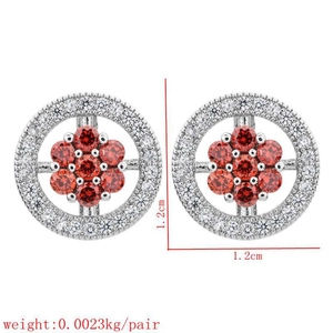 Close-up of 1.2cm round floral earrings with white zircons and red gemstone centers