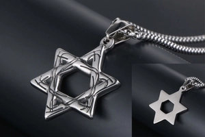 Macro detail of silver star of David pendant with thorn texture and smooth back side