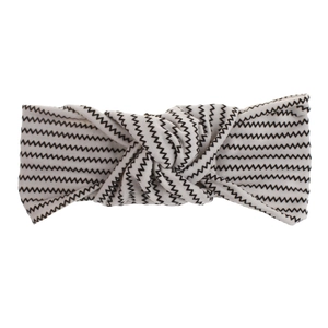 Detail of bohemian cream headband with black zigzag print and center twist knot design