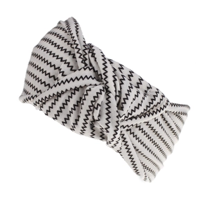 Detail of bohemian wide headband featuring a black and white zigzag pattern with center knot