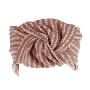Close-up of caramel bohemian headband featuring a twisted knot and white zigzag pattern