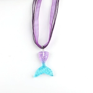 Detail of mermaid tail pendant with purple-blue gradient finish and shimmer texture