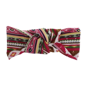 Detail of bohemian printed headband with elastic knit fabric and vibrant knot design