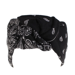 Close-up of black and white paisley print headband with twisted knot fabric detail