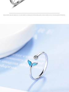 Macro view of silver-tone fishtail ring with blue enamel and sparkling round zircon