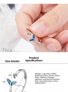 Macro view of adjustable silver mermaid tail ring with blue enamel and zircon detail