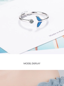 Detail of S925 silver open ring with blue fishtail design and round cubic zirconia