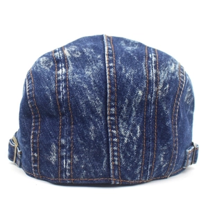 Detail view of denim beret back with adjustable metal buckles and stitching lines
