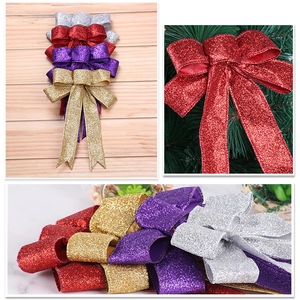 Detailed view of glittered Christmas bows in assorted colors for festive tree decoration