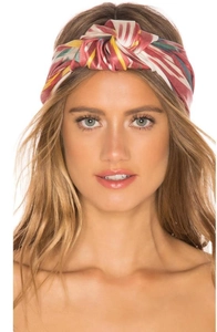 Detail of bohemian criss-cross headband featuring vibrant red and yellow geometric patterns