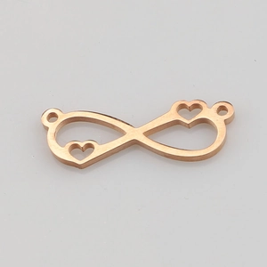Macro detail of rose gold infinity heart connector with mirror polished finish