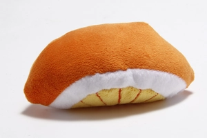 Detail view of salmon sushi plush toy with orange, white and yellow velvet texture