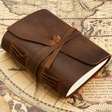 Detail of crazy horse leather bookmark with handmade stitching on vintage map background