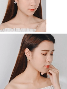 Close-up of elegant bow-shaped earrings with sparkling cubic zirconia on model