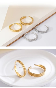 Close-up of feather texture and open adjustable band on gold and silver rings