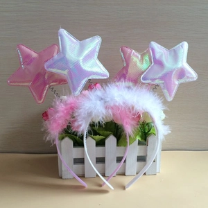 Detail of white halo headbands with fuzzy feathers and iridescent laser star ornaments