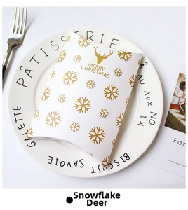 Close-up of a white pillow gift box with golden reindeer and Merry Christmas text
