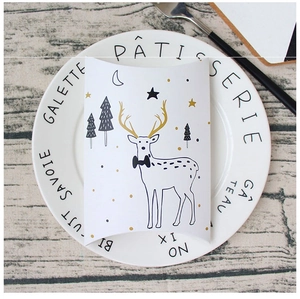 Elegant white pillow-shaped gift box featuring cartoon deer and star patterns on a ceramic plate