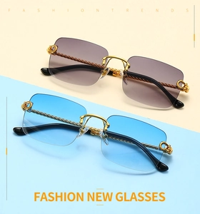 Detail view of rimless square sunglasses with twisted metal temples in gold and blue