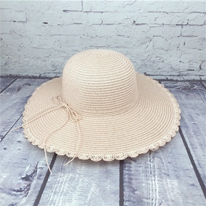 Women summer straw hat with wide wavy brim and bow decoration for sun protection