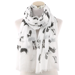 Detail of white scarf featuring black dog prints and elegant fringe tassels on the edges