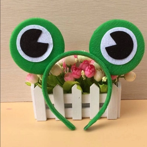Close-up of green frog eye headband featuring plush fabric texture and 3D stuffed eyes