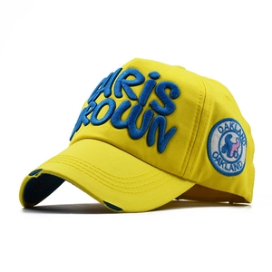 Detail of yellow cotton baseball cap with blue Paris Brown embroidery and vintage worn brim