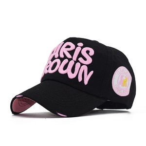 Detail of black baseball cap with 3D pink embroidery and distressed brim details