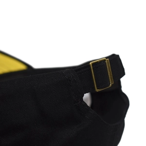 Detail of adjustable metal buckle on black cotton baseball cap for custom sizing