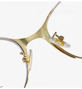 Detailed macro view of comfortable silicone nose pads on gold cat-eye metal glasses frame