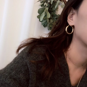 Close-up of elegant gold hoop earrings worn on ear for a minimalist jewelry look