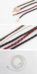 Close-up of woven PU leather waist belts in multiple colors with elegant gold metal tips