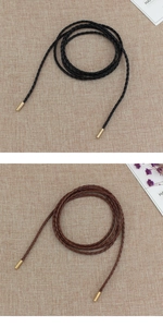 Detailed macro view of woven PU leather waist ropes with gold metal cylinder end caps